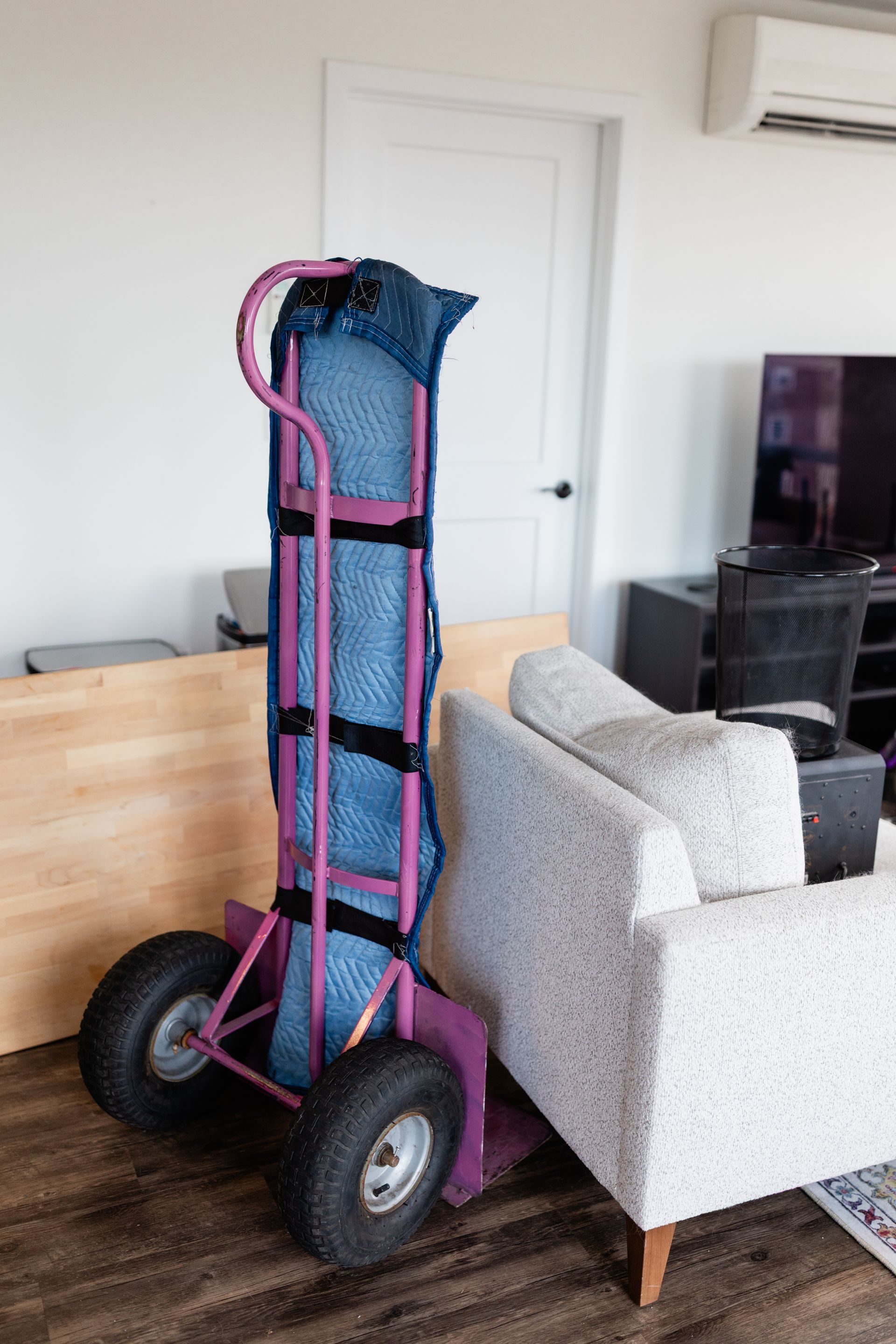 pink hand truck with padding for protection