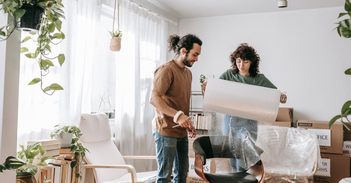 A man and a woman are moving into a new home.