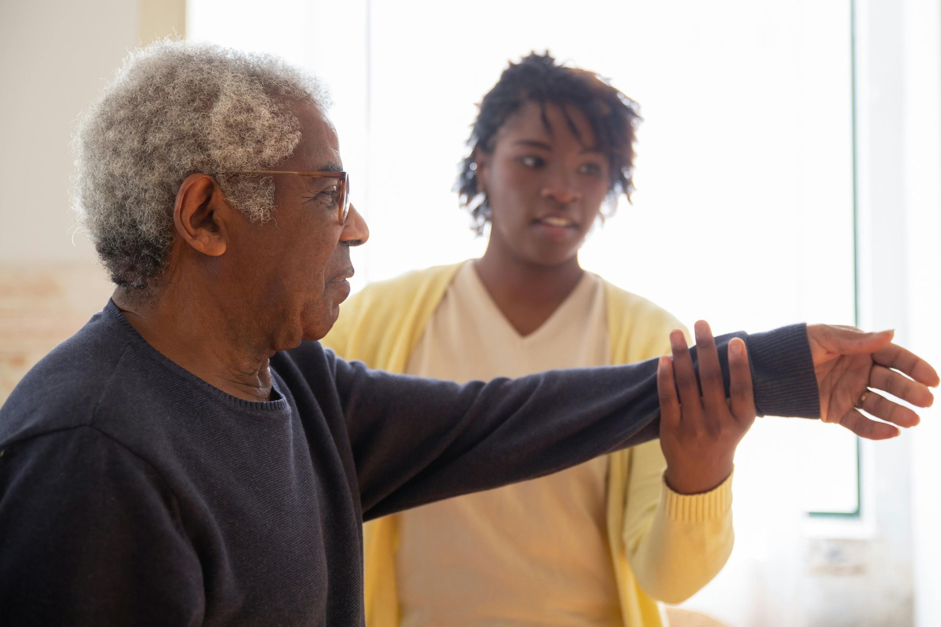 therapist helping patient with arm mobility