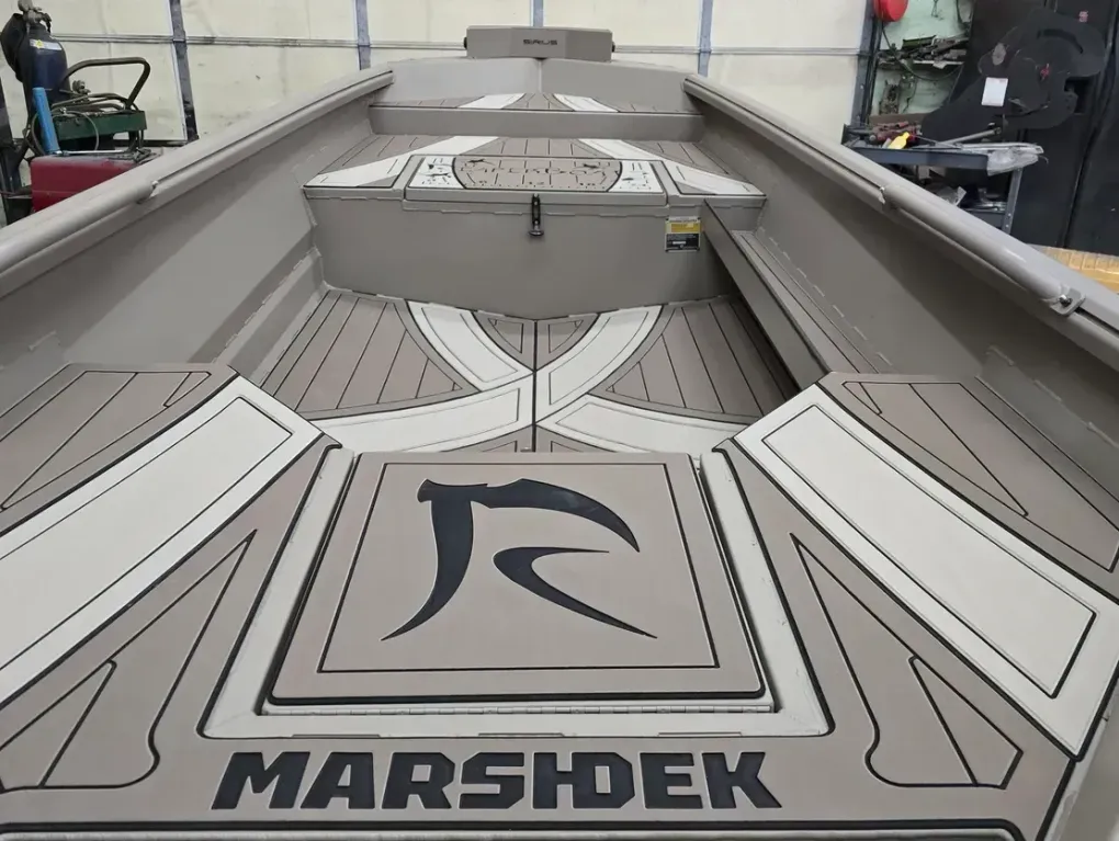 Interior of a gray Marshdek boat with deck panels and a central storage box.