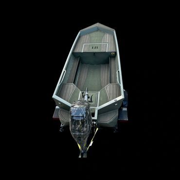 Small gray motorboat seen from above on a black background, with bow and interior seating visible