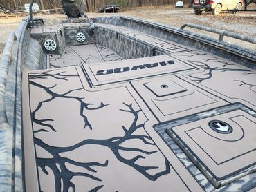 Car with custom gray trunk mural of a cracked stone path and tree branches in a trailer