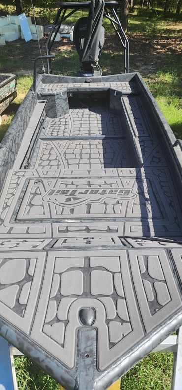 Gray stone coffin-shaped outdoor fountain with carved patterns and a narrow central channel