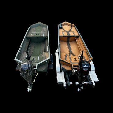 Two small motorboats, one gray and one orange, side by side on a black background.