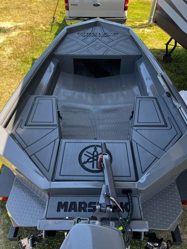 Gray Mars recreational vehicle on grass, viewed from front with hatch open and trailer hitch visible