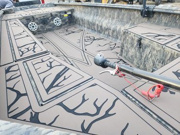 Graffiti-covered empty concrete pool with a drain pipe and painted black branching lines on the floor