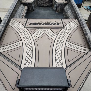 Decorated boat deck with geometric gray-and-black vinyl flooring and a black bench at the front