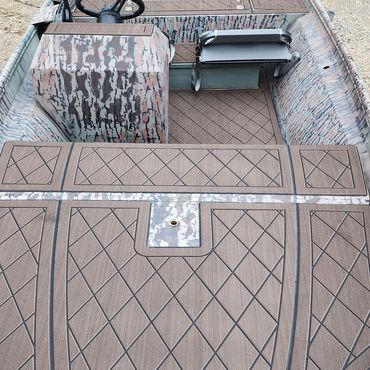 Top-down view of a tan deck with diamond pattern, a weathered chair, and two stacked stools near the railing