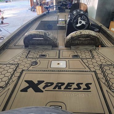 Tiled work surface with Xpress logo and two front tires inside an auto shop[0m
