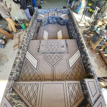 Geometric patterned burial casket in a workshop, viewed from above.