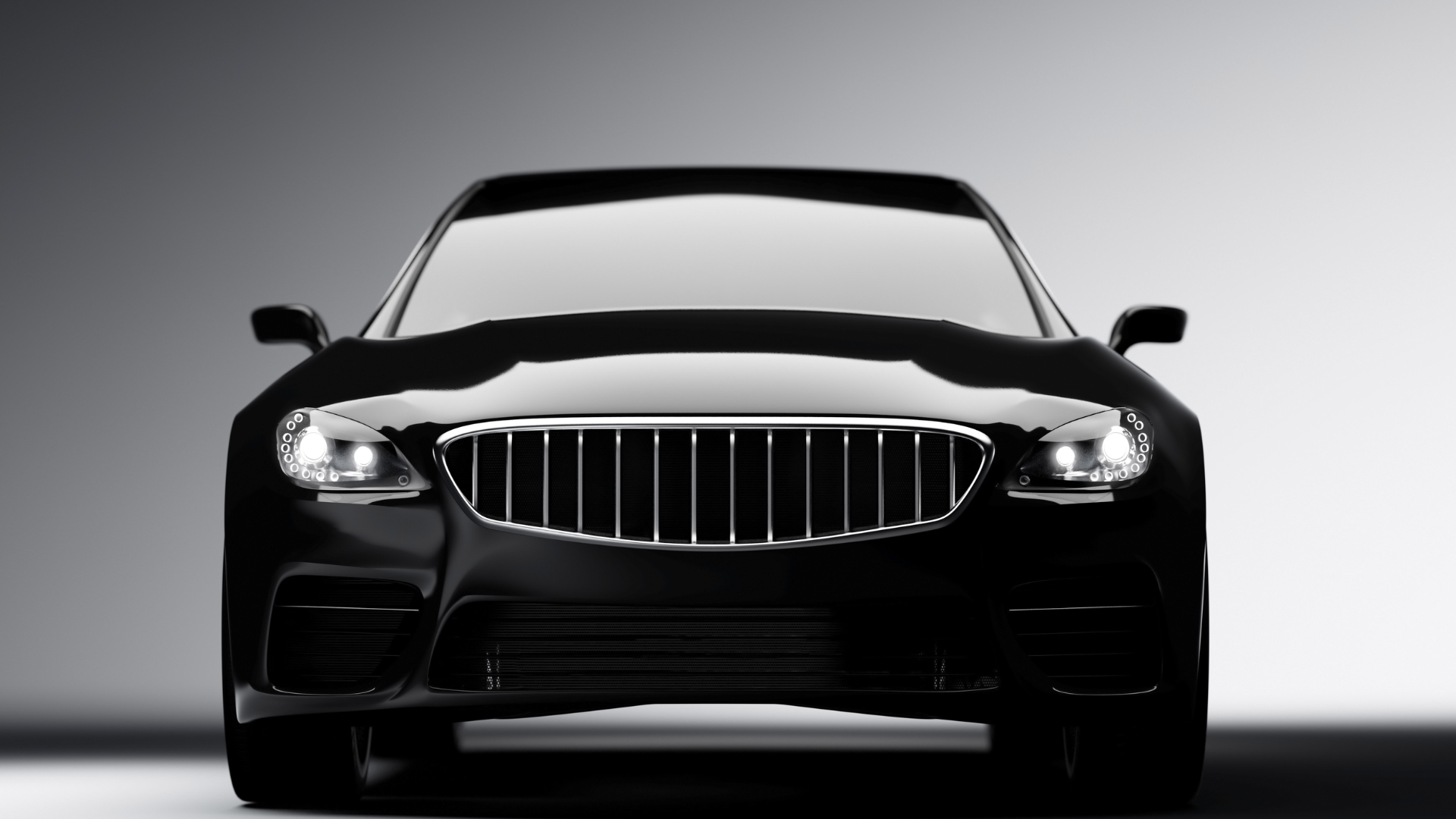 Front view of a sleek black luxury sedan on a white background