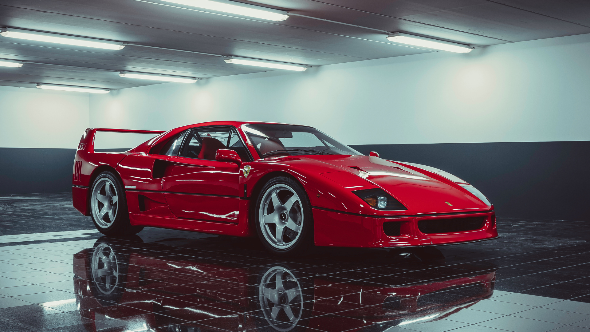 Red sports car with gullwing doors open in a glossy showroom, reflected on the polished floor