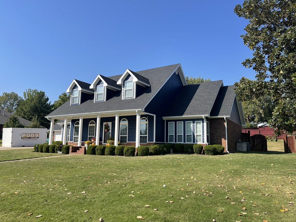 A large house with a large lawn in front of it.