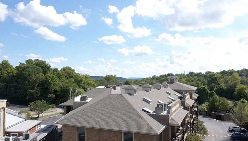 An aerial view of a residential area with a lot of buildings and trees