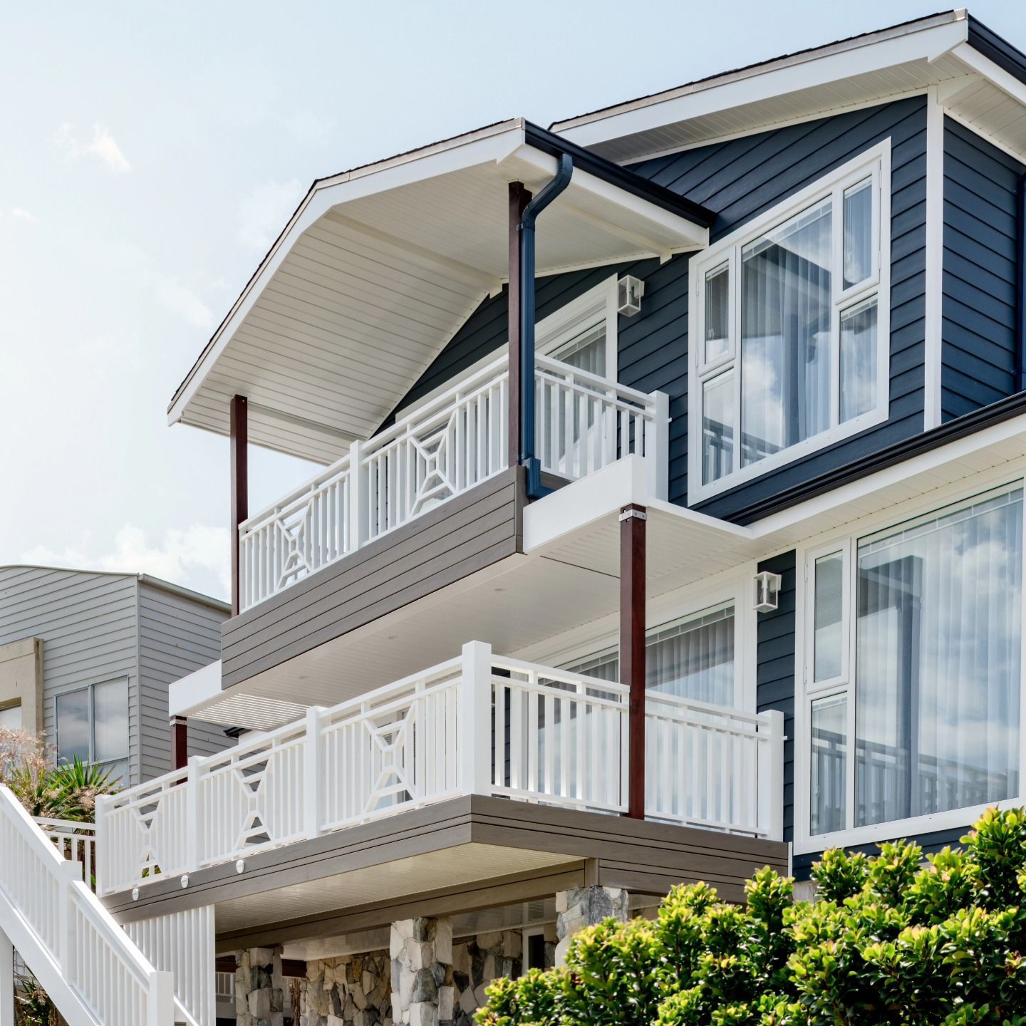 Modern Two Story House with White Balconies and A Landscaped Front — QBC Constructions In Gerringong, NSW