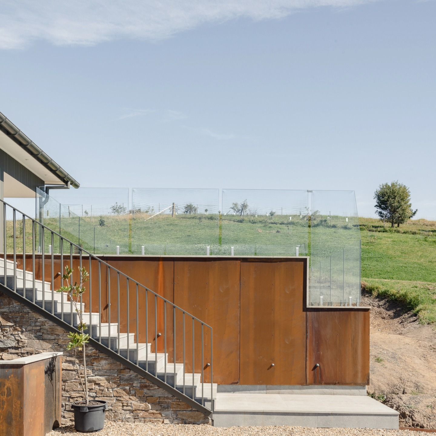 Modern House Patio with Glass Railing and Grassy Hillside — QBC Constructions In Gerringong, NSW