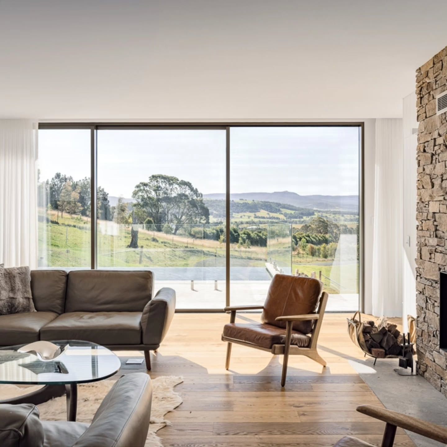 Modern Two Story House with Warm Lights and Large Windows at Dusk — QBC Constructions In Berry, NSW