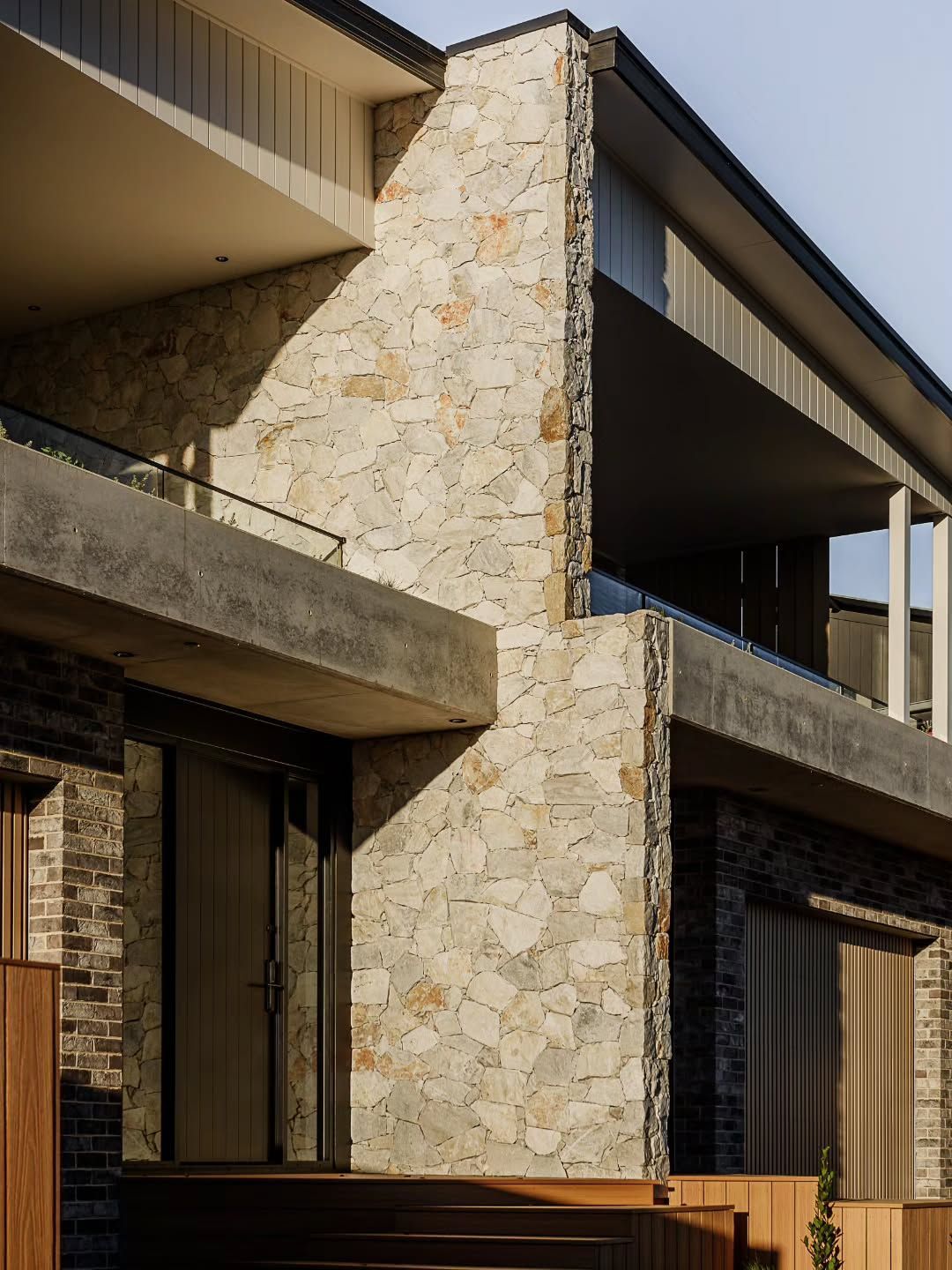 Modern Stone Building Exterior with Balconies and Shaded Windows — QBC Constructions In Kiama, NSW
