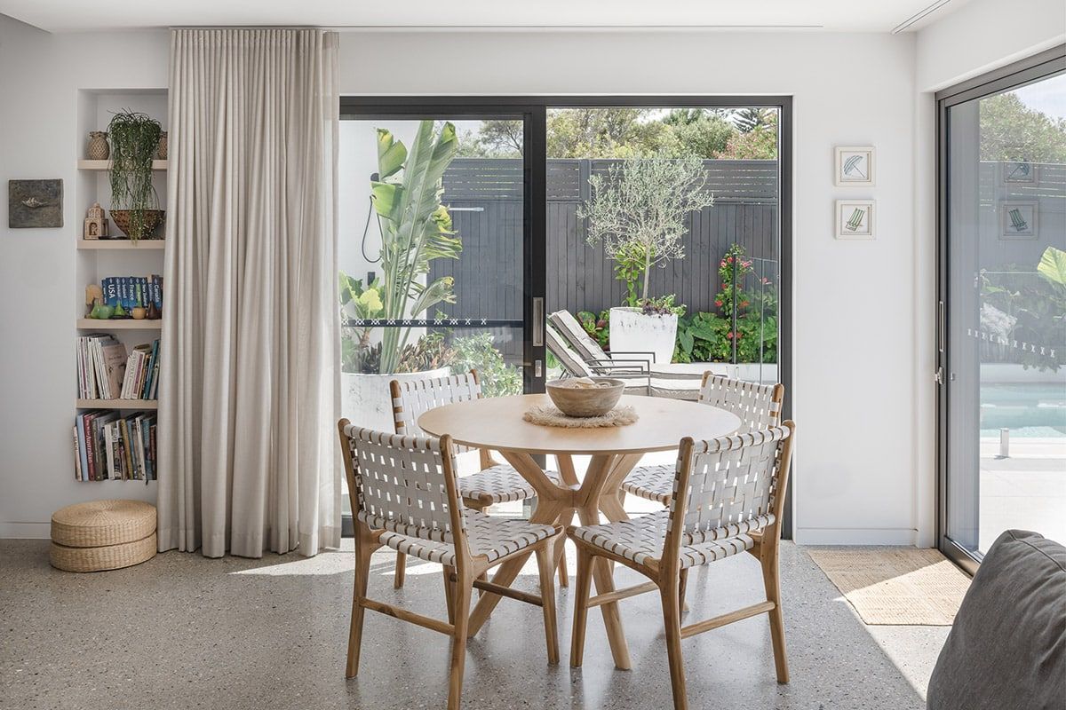 A Dining Room With A Table And Chairs And A Sliding Glass Door — QBC Constructions In Werri Beach, NSW