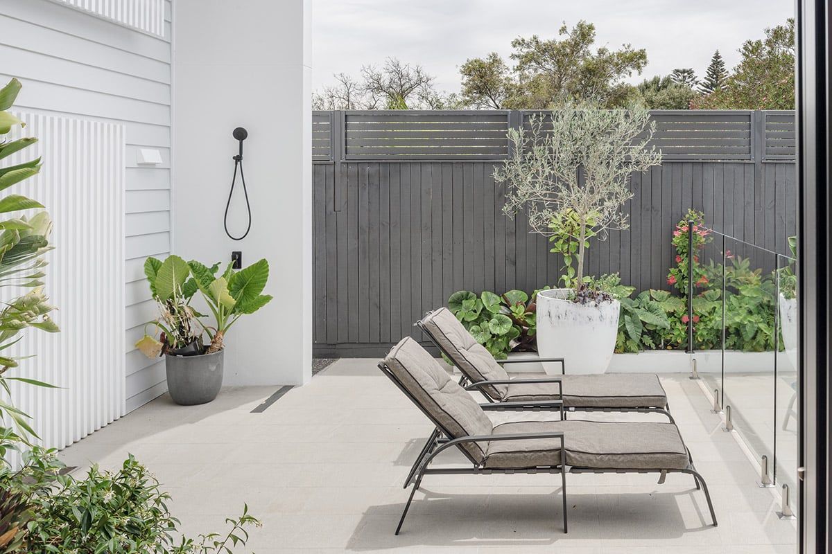 A Patio With Lawn Chairs And A Potted Plant — QBC Constructions In Werri Beach, NSW