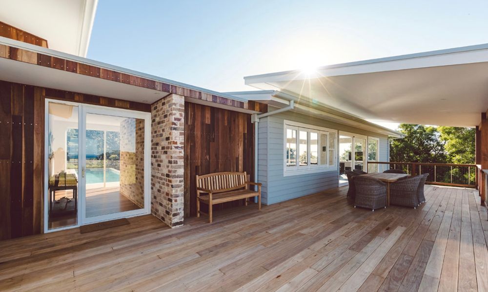 There is a Large Wooden Deck With a Table and Chairs on It — QBC Constructions In Willow Vale, NSW