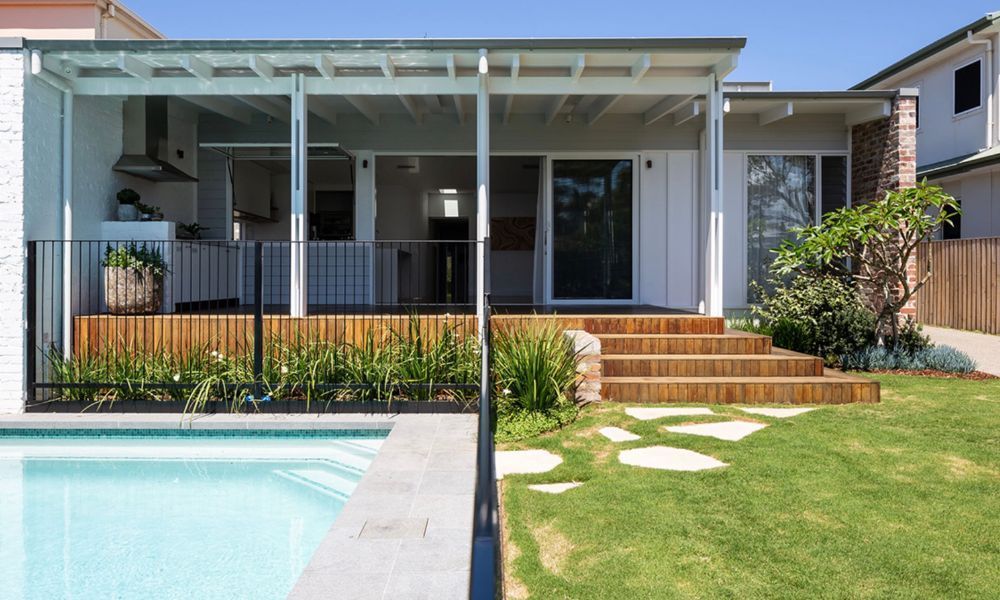 A House With a Swimming Pool in Front of It — QBC Constructions In Pacific Avenue, QLD