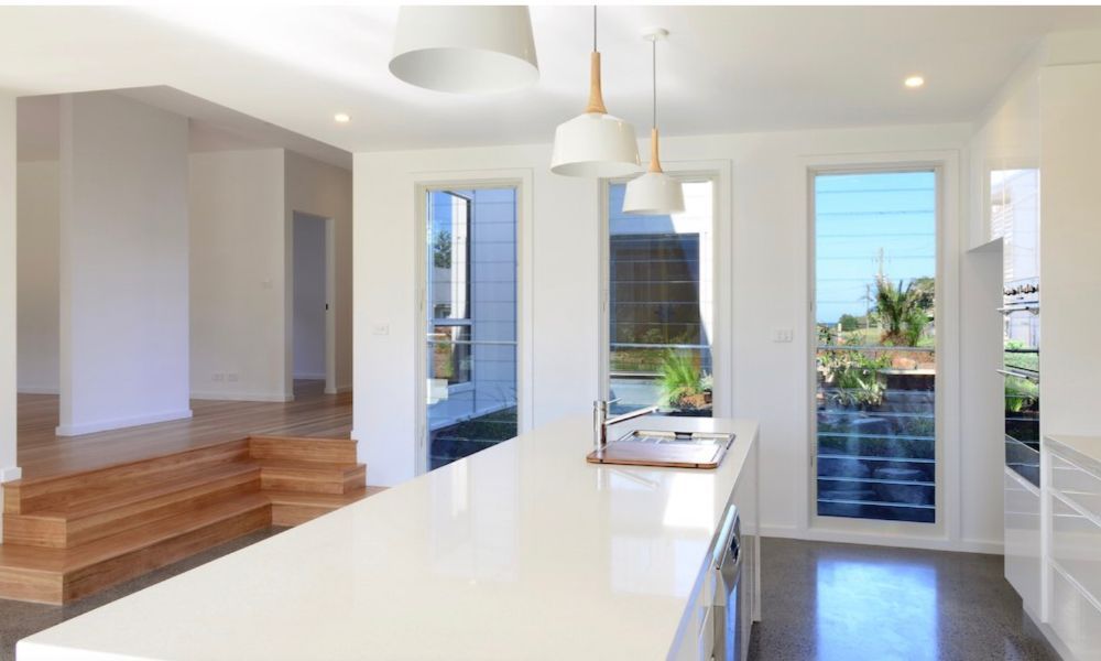 A Kitchen With a Large Island in the Middle of It — QBC Constructions In Gerringong, NSW