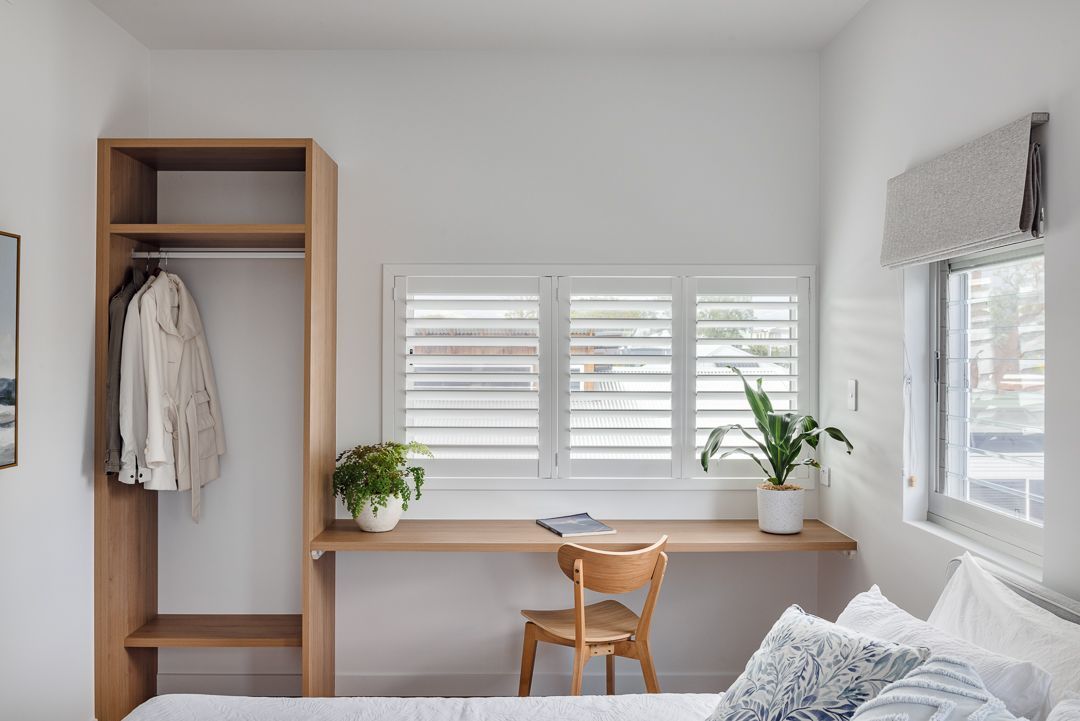 A Bedroom With a Bed , Desk , Chair and Closet — QBC Constructions In Werri Beach, NSW