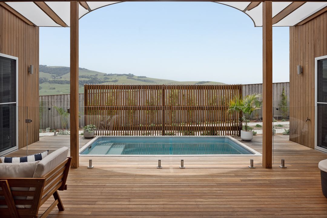 A Modern Wooden House With A Fence Surrounding it — QBC Constructions In Werri Beach, NSW