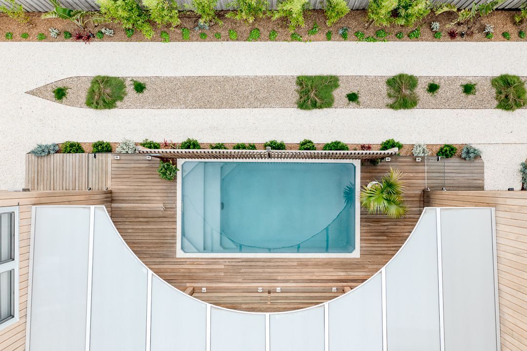 An Aerial View of a Swimming Pool Surrounded by a Wooden Deck — QBC Constructions In Werri Beach, NSW