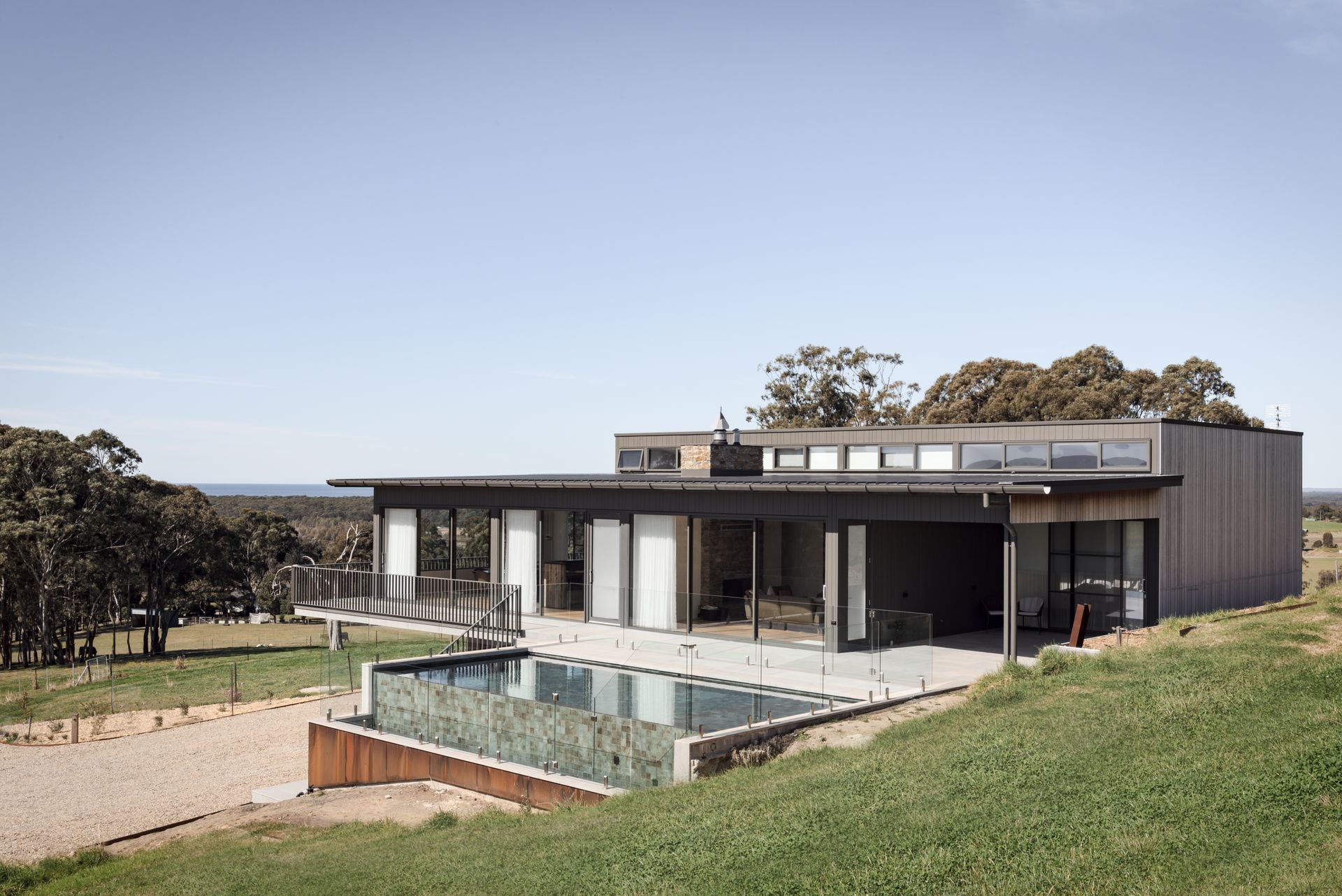 A Large House With a Swimming Pool in Front of It — QBC Constructions In Seven Mile Beach, NSW