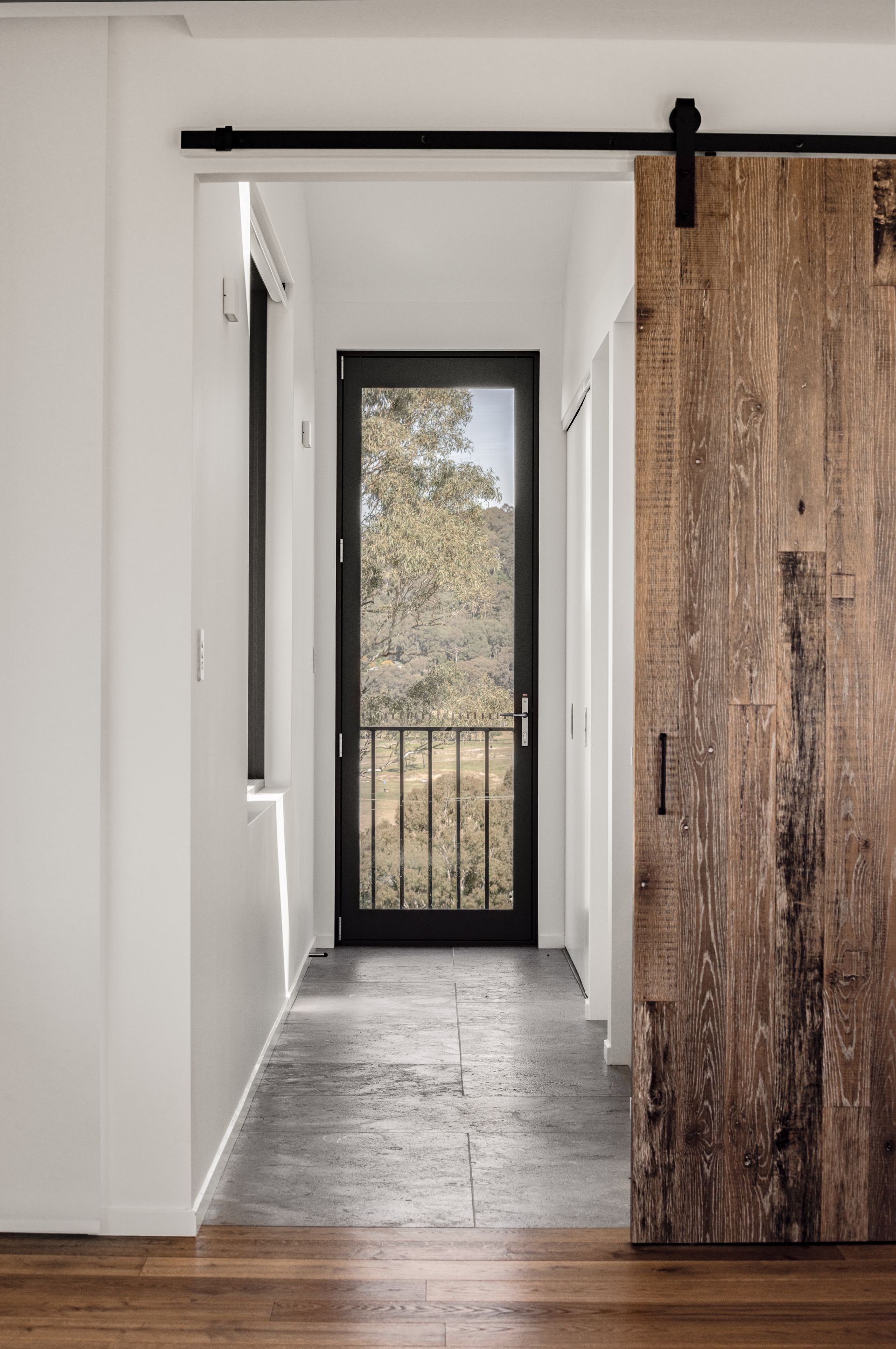 A Hallway With a Sliding Barn Door — QBC Constructions In Seven Mile Beach, NSW
