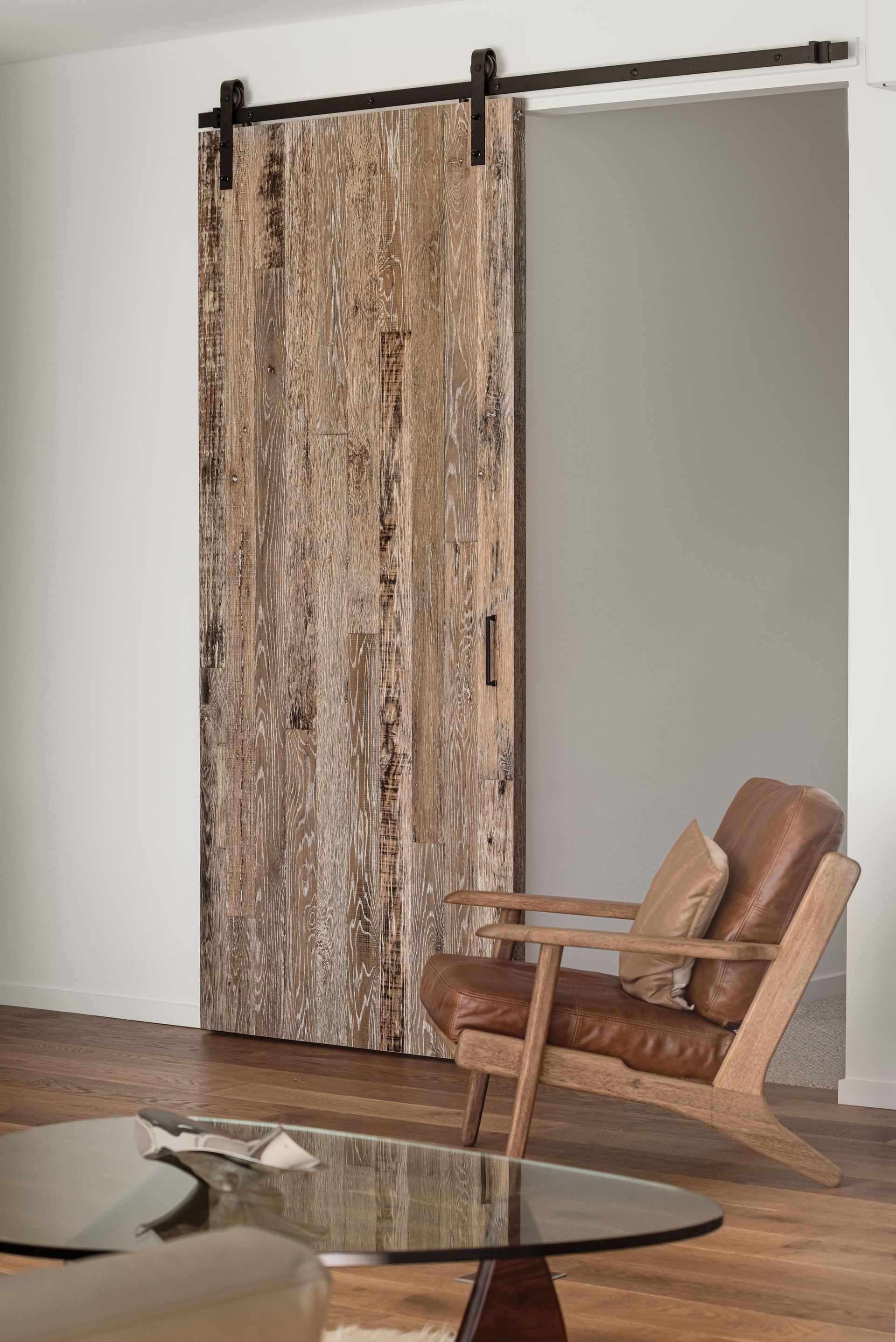 A Living Room With a Sliding Barn Door — QBC Constructions In Seven Mile Beach, NSW