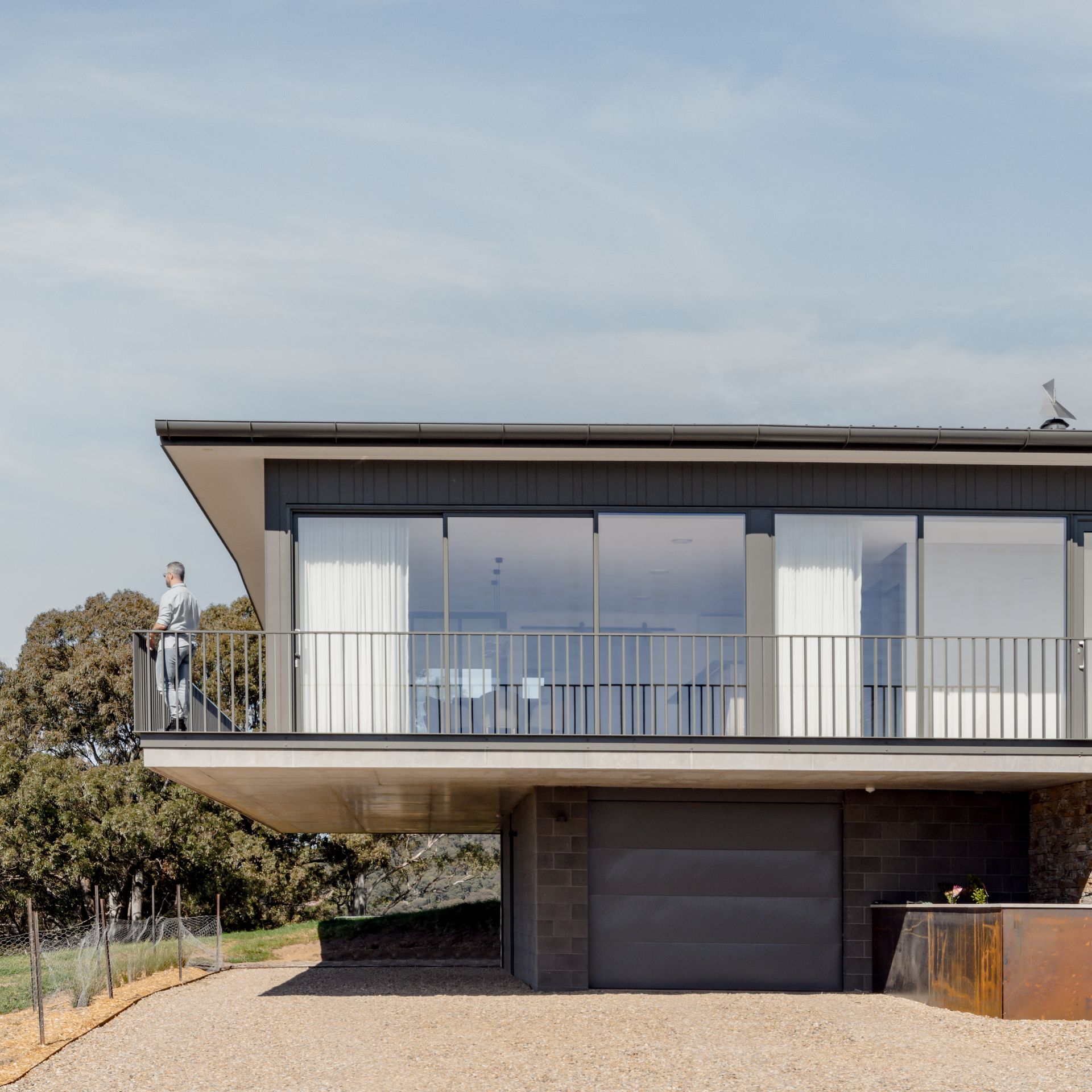 A Large House With a Lot of Windows and a Balcony — QBC Constructions In Seven Mile Beach, NSW