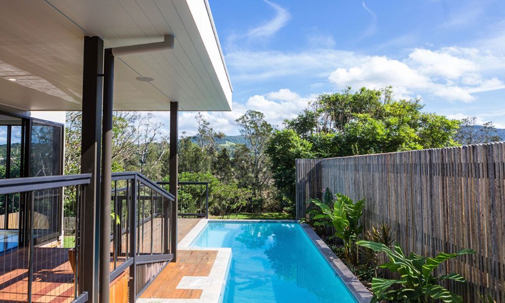 There is a Large Swimming Pool in the Backyard of a House — QBC Constructions In South Coast, NSW