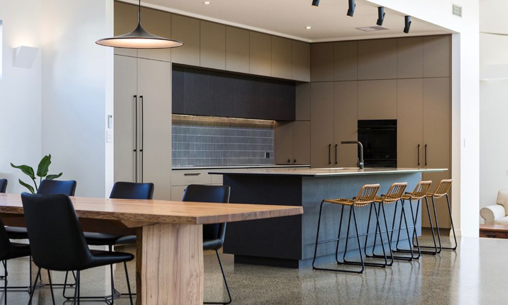 A Kitchen With a Table and Chairs in It — QBC Constructions In South Coast, NSW