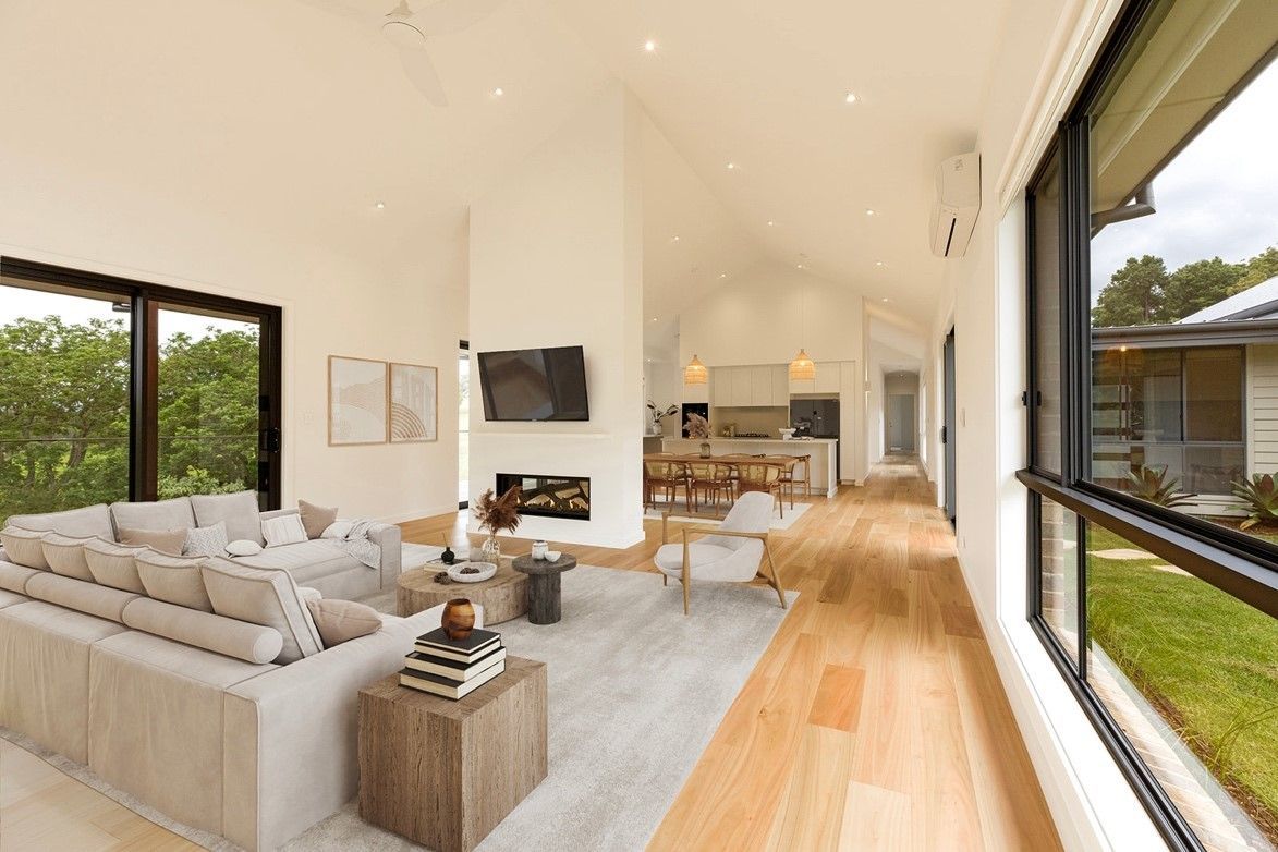 A Living Room With a Couch, Chairs, Table and Television — QBC Constructions In Curramore, Queensland