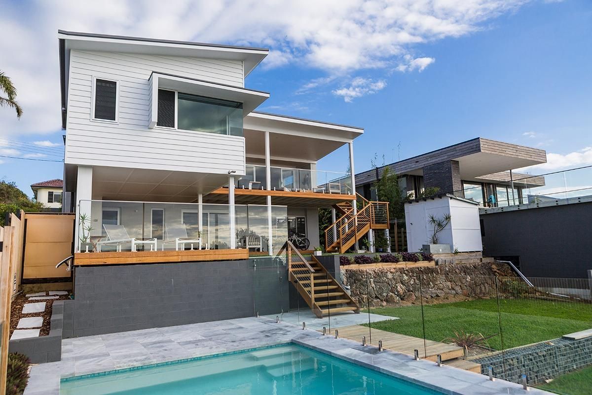 A Large House With A Swimming Pool In Front Of It — QBC Constructions In Werri Beach, NSW