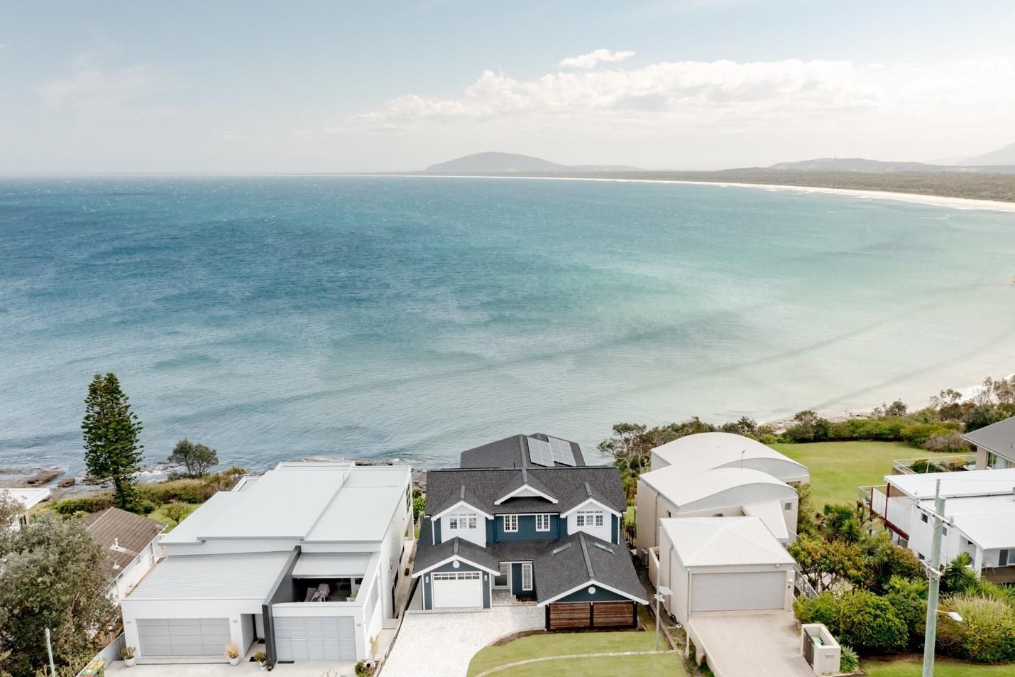 An Aerial View of a House Next to the Ocean — QBC Constructions In Gables, NSW