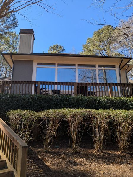 A house with a large deck and stairs leading up to it.