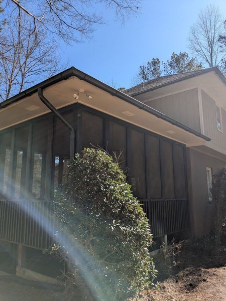 A house with a screened in porch on a sunny day