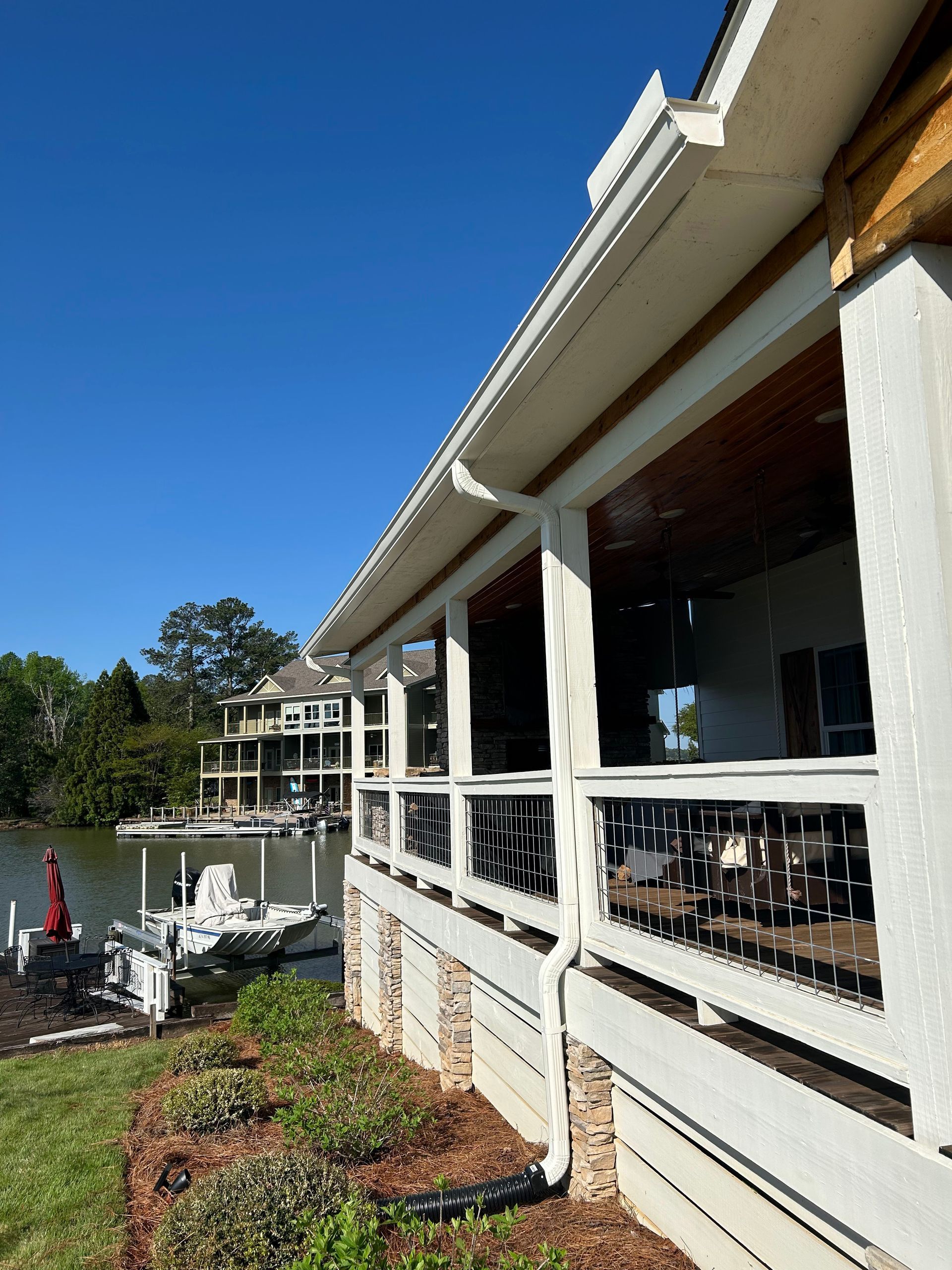 A house with a large porch overlooking a body of water