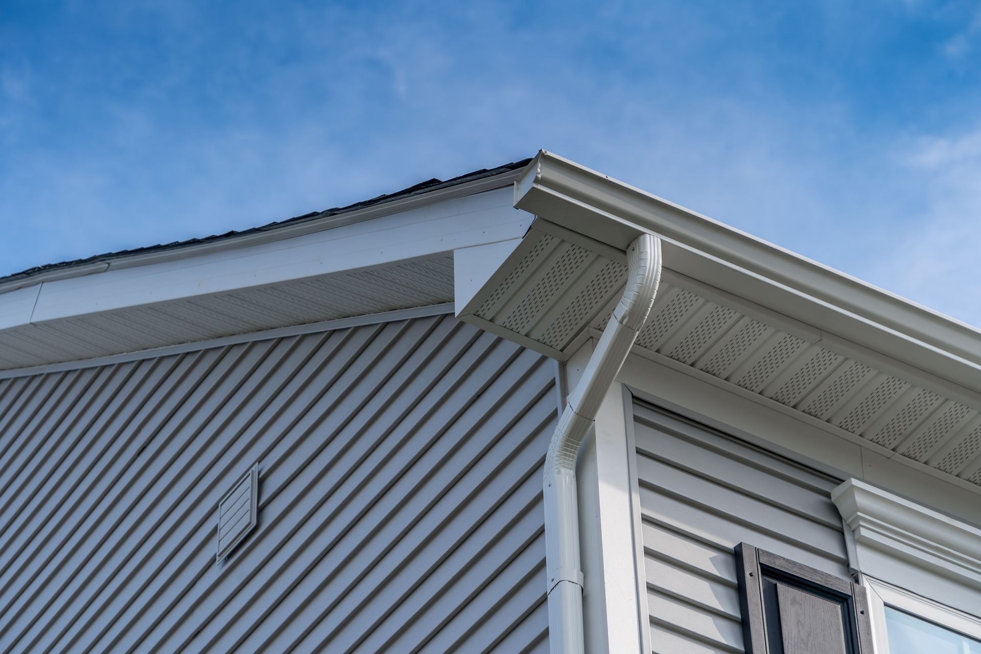The Roof of a House and Gutter With a Blue Sky