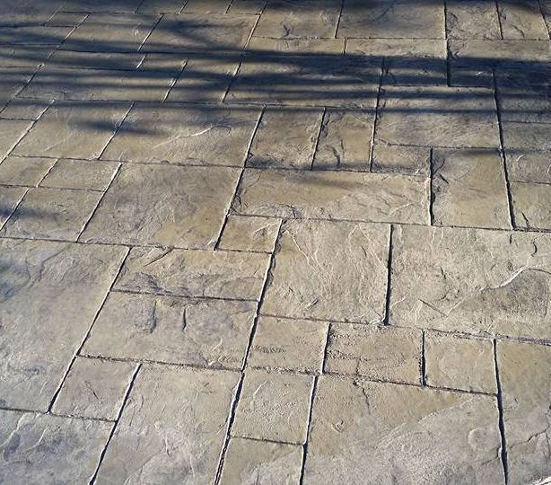 A brick floor with a tree shadow on it