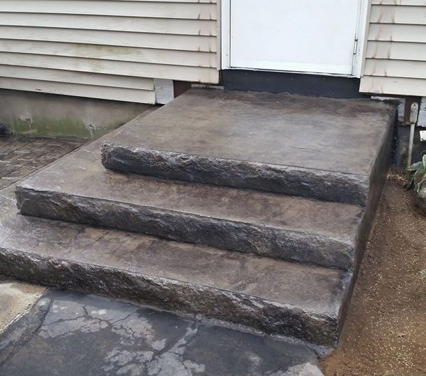 A set of concrete steps leading up to a house