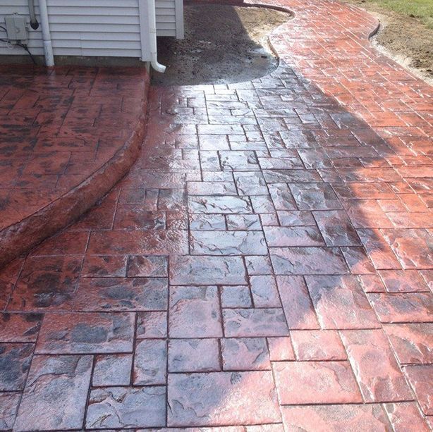 A brick walkway with a white house in the background