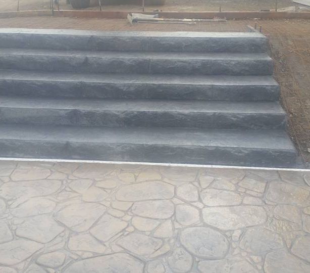 A set of stairs sitting on top of a stone patio.