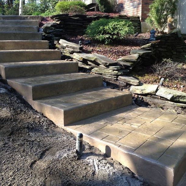 A set of stairs leading up to a stone wall