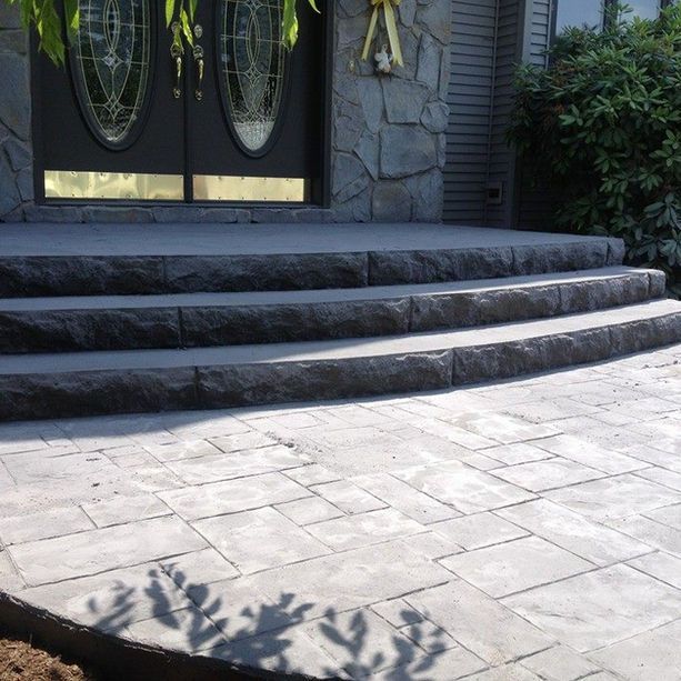 A stone walkway leading to the front door of a house