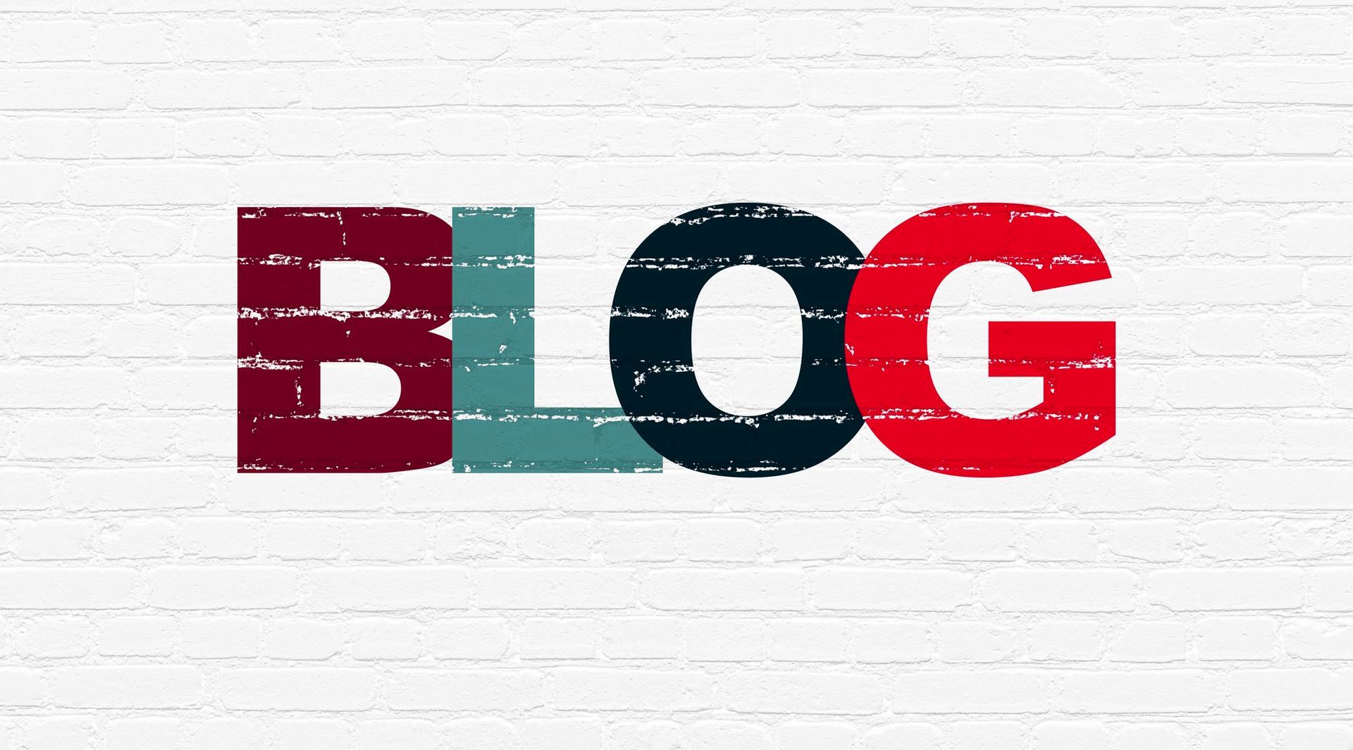 The word blog is written on a white brick wall.